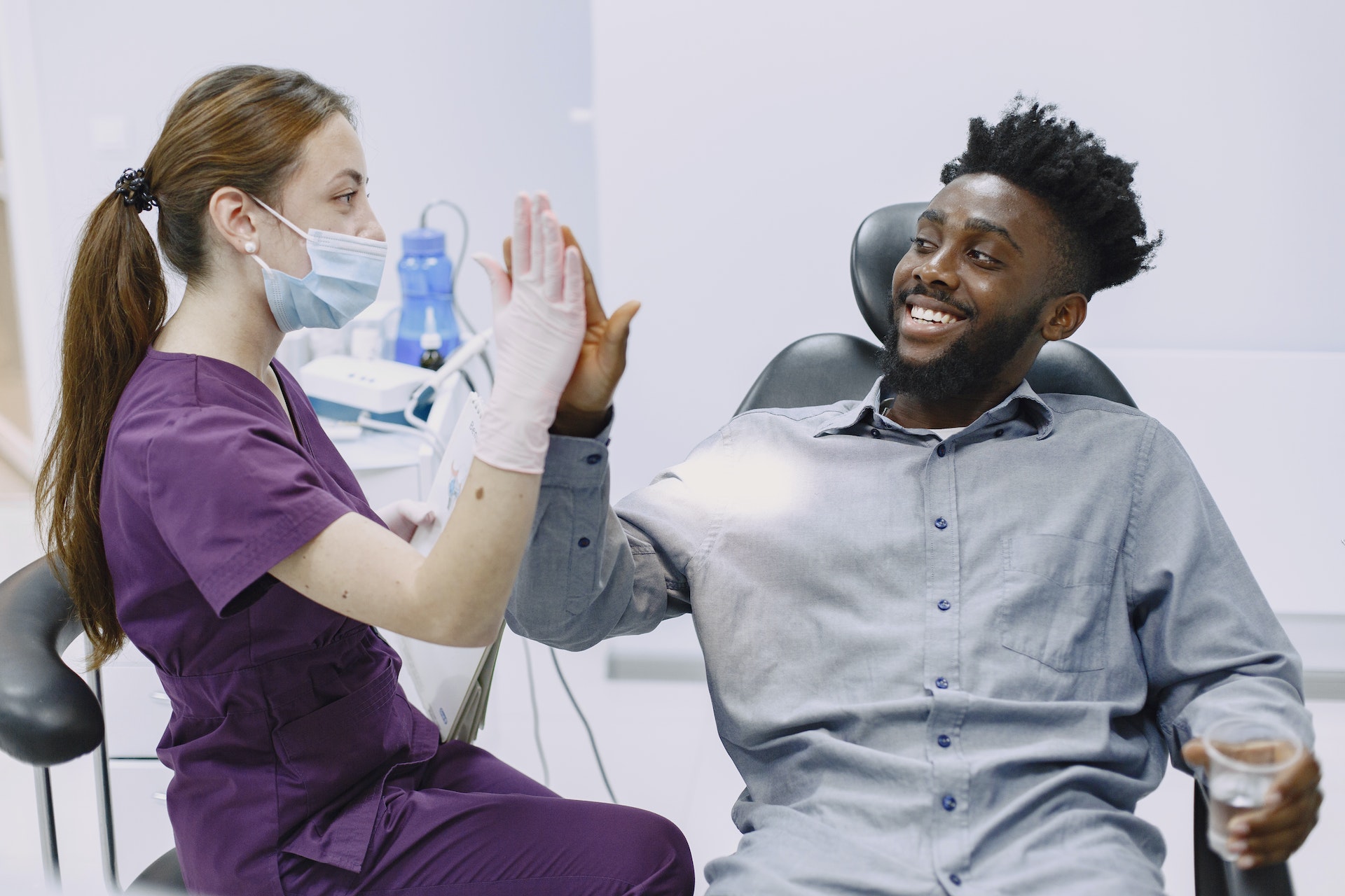 A man high-fiving a dentist