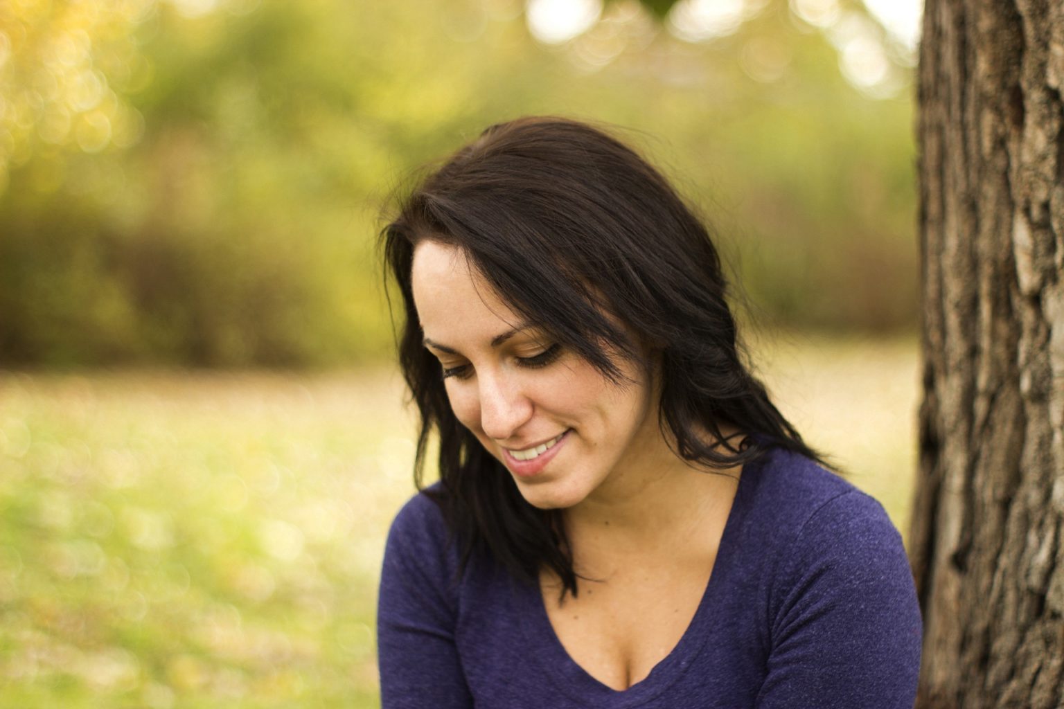 woman smiling while looking down