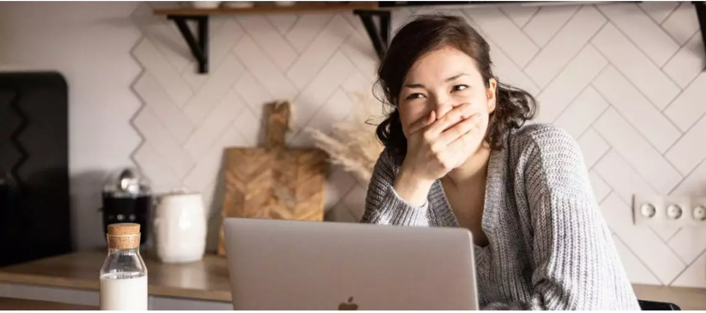 Woman covering her mouth to get rid of bad breath