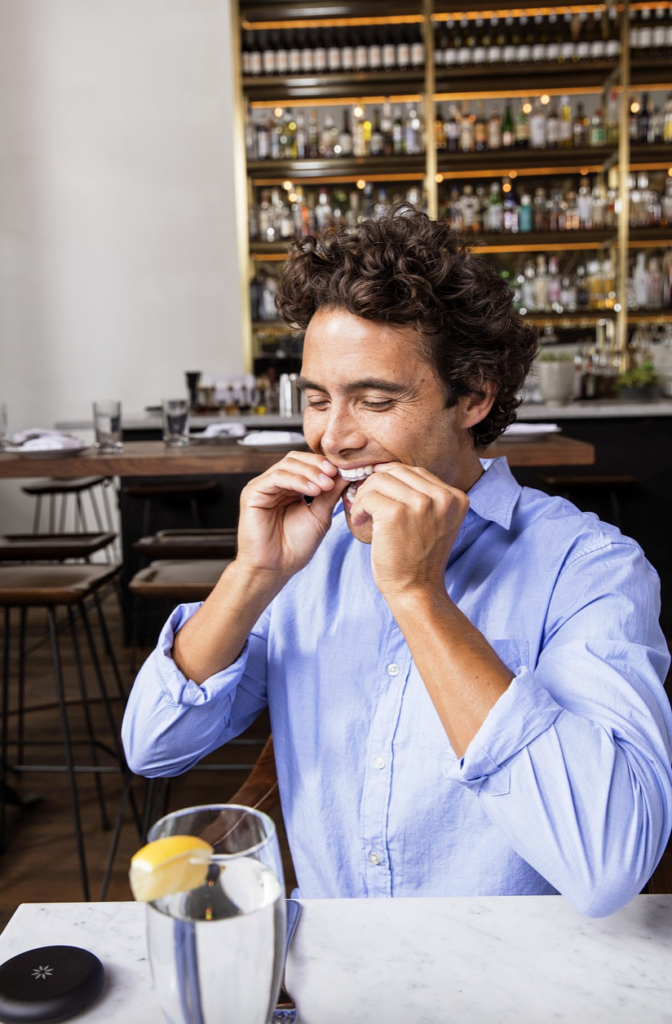 man with aligners at a restaurant