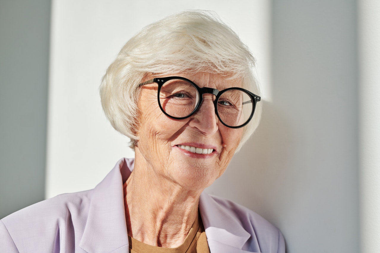 woman with glasses smiling