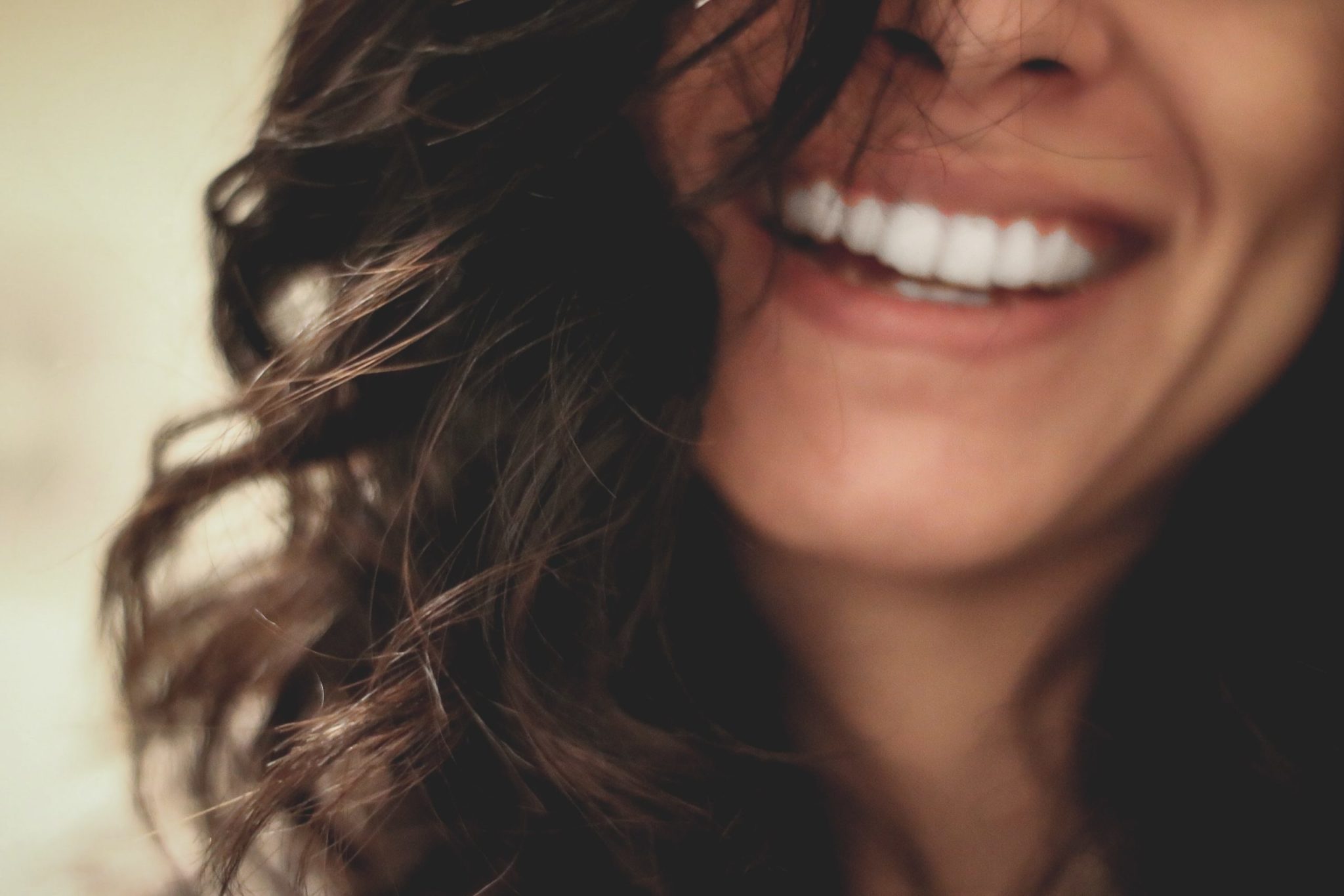 A young woman smiling and revealing perfect teeth