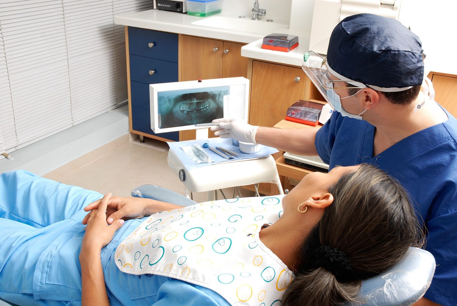 dentist explaining x-ray results to a patient during a visit