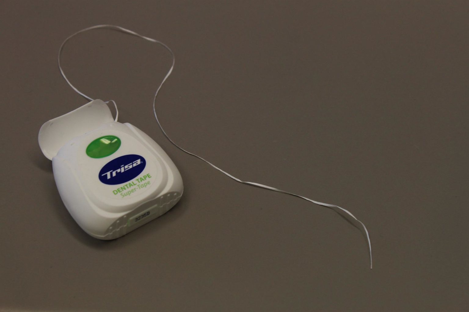 floss container on a gray surface