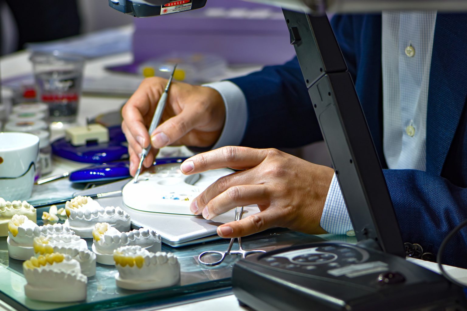 A technician working on dental crowns