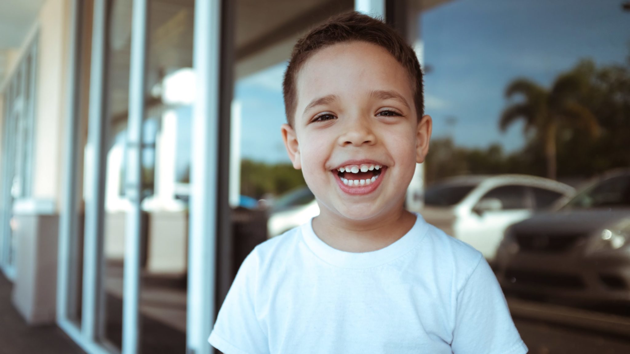 A boy with a loose tooth smiles