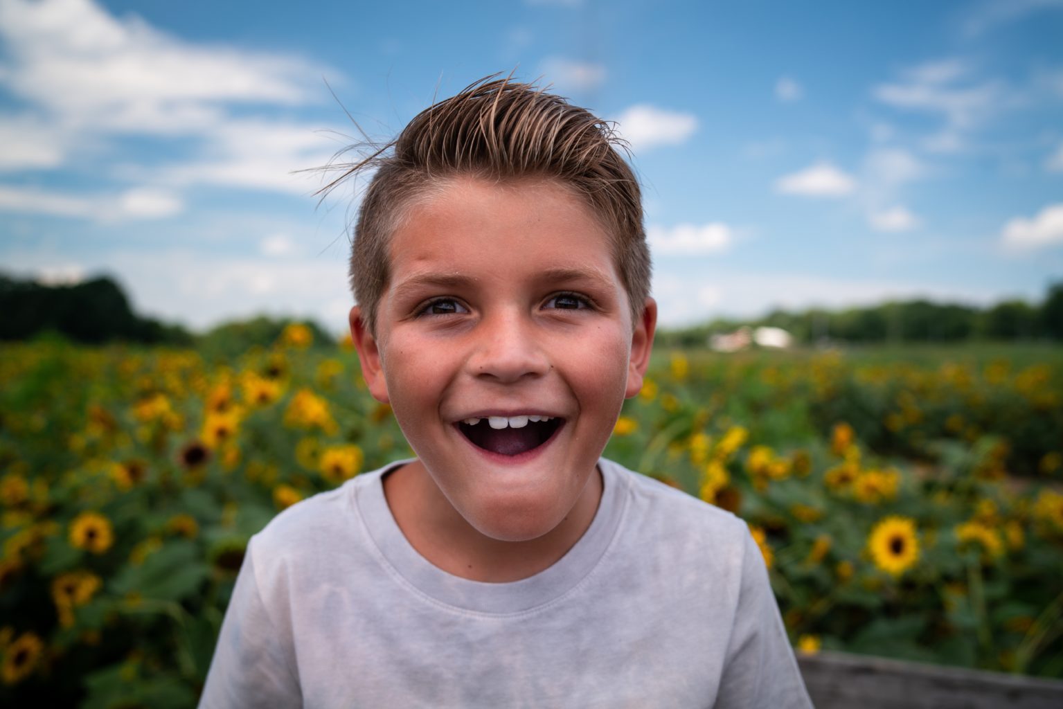 A young boy with a gap in his smile from losing a baby tooth