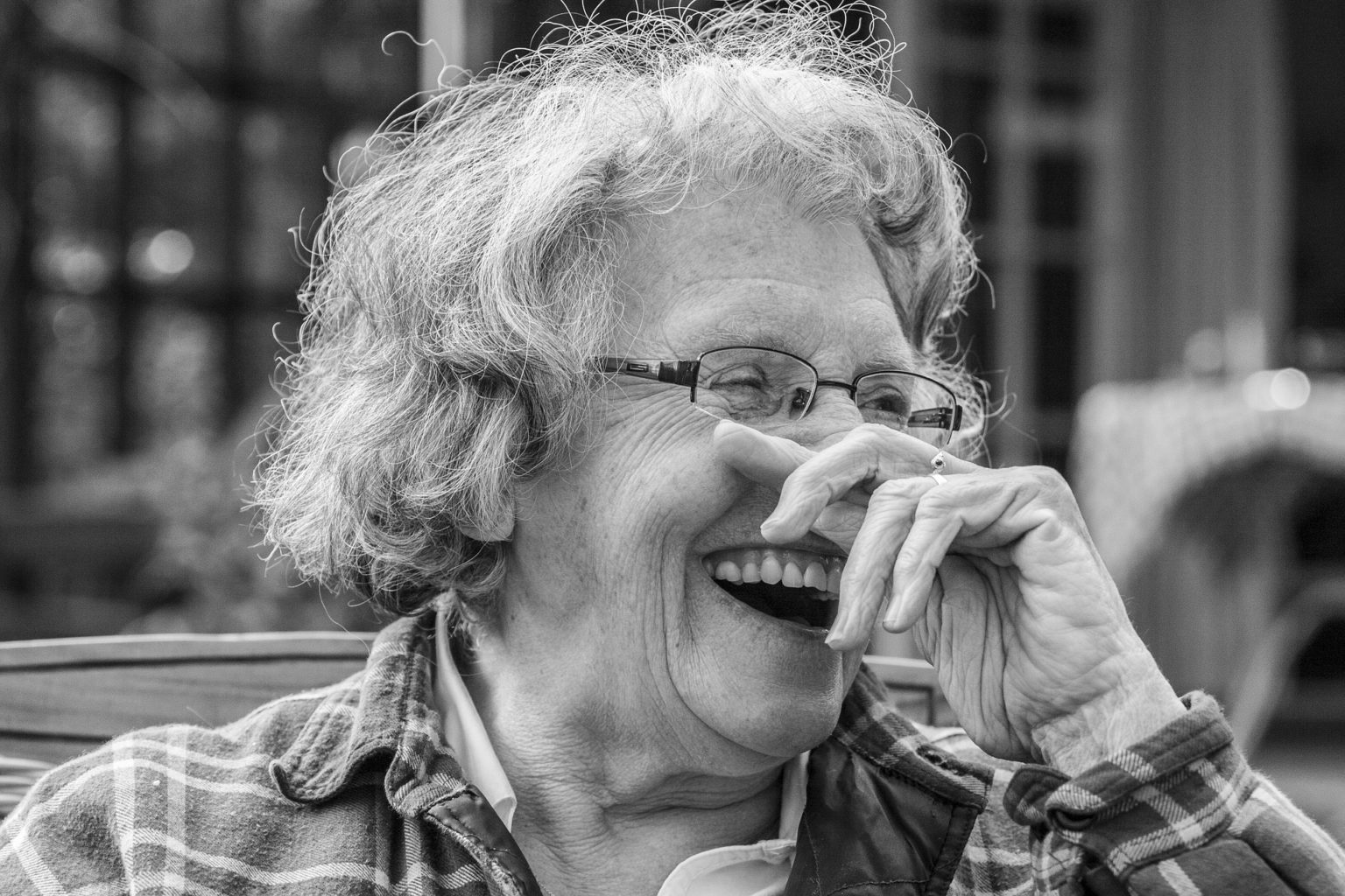 A woman laughing and showing her teeth