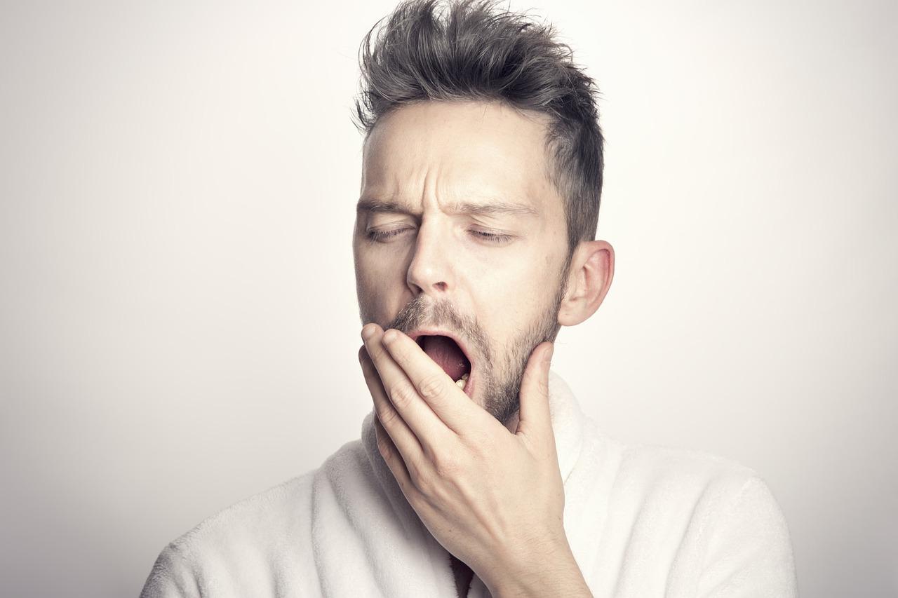 A man with sleep apnea yawning