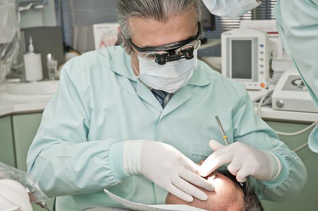 dentist looking at a man’s teeth