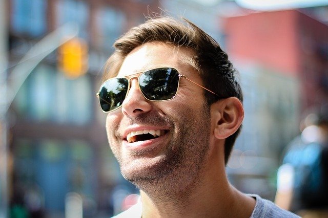 man with smile and sunglasses after clear aligners