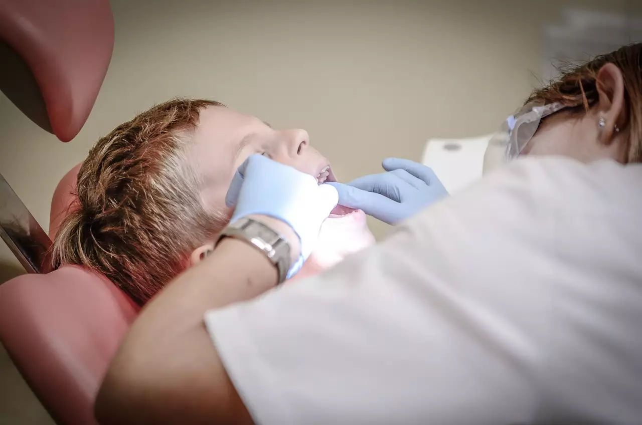 dentist looking in boy’s mouth