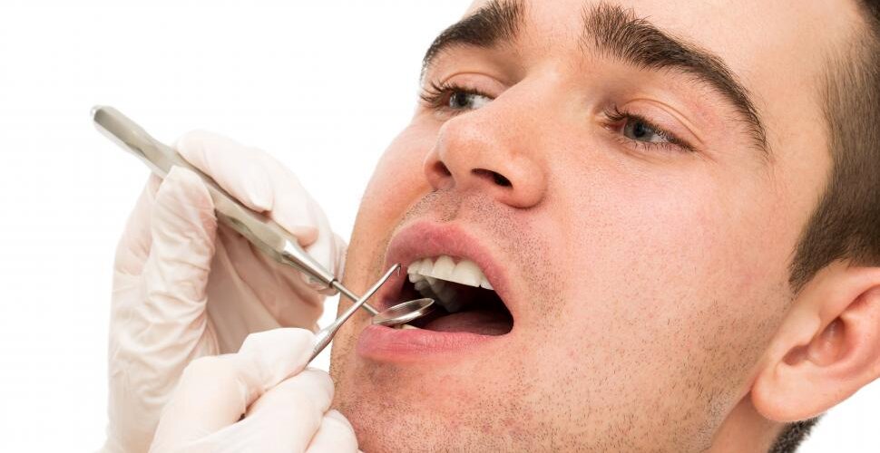 A close image of a man’s face during a dental examination