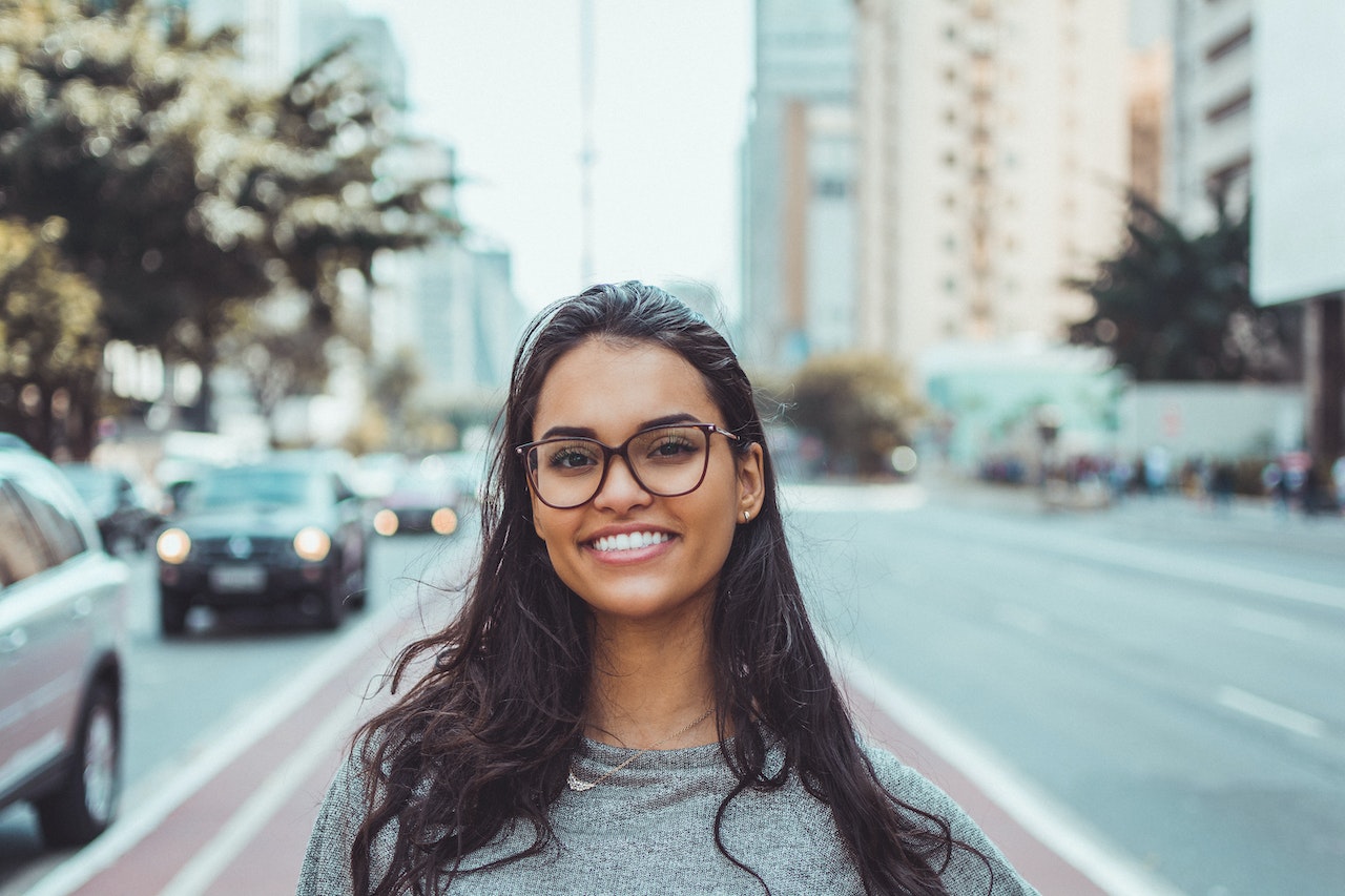 Girl smiling, standing on the road