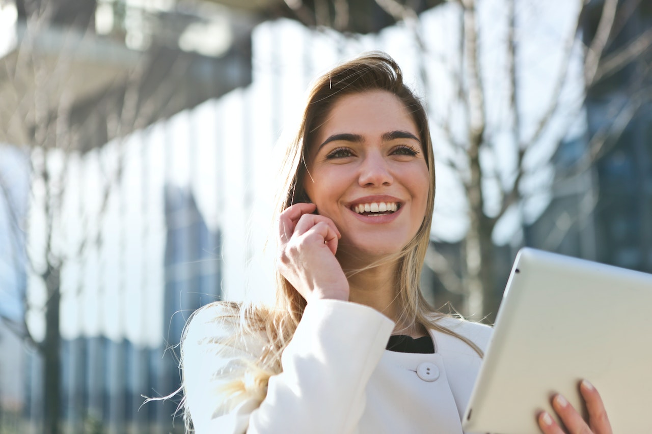 Woman smiling while talking on her phone