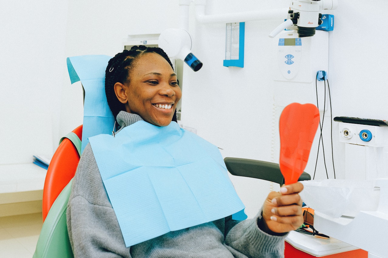Woman looking at her teeth at a dental clinic