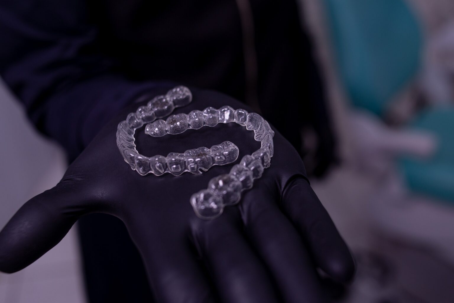 Clear aligners on a person’s hand