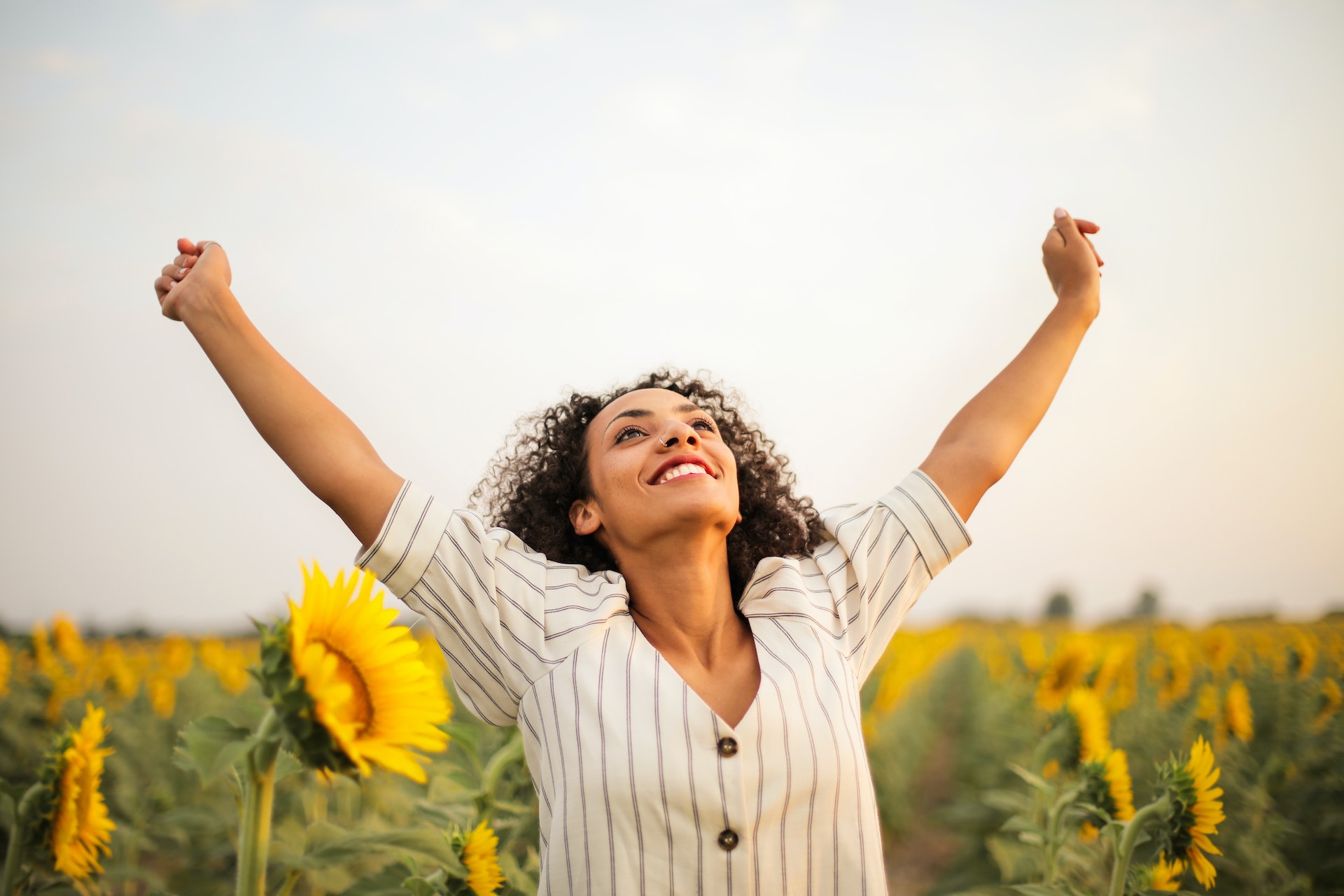 Woman smiling in sunflower field