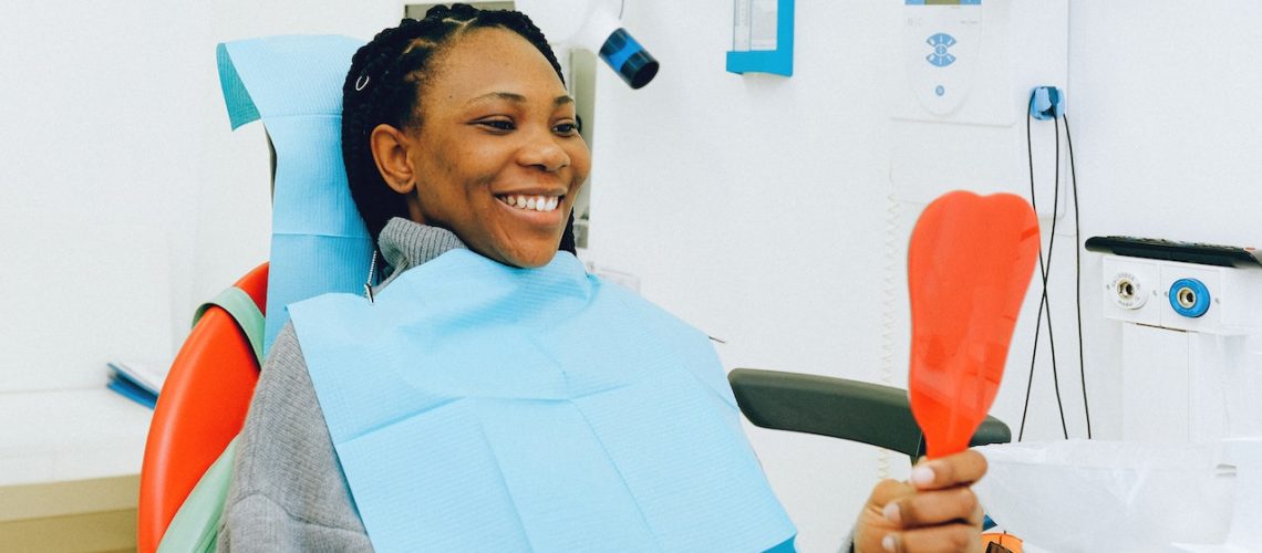 Woman looking at her teeth at a dental clinic