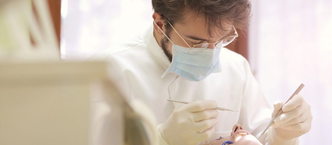 Dentist examining a patient’s teeth