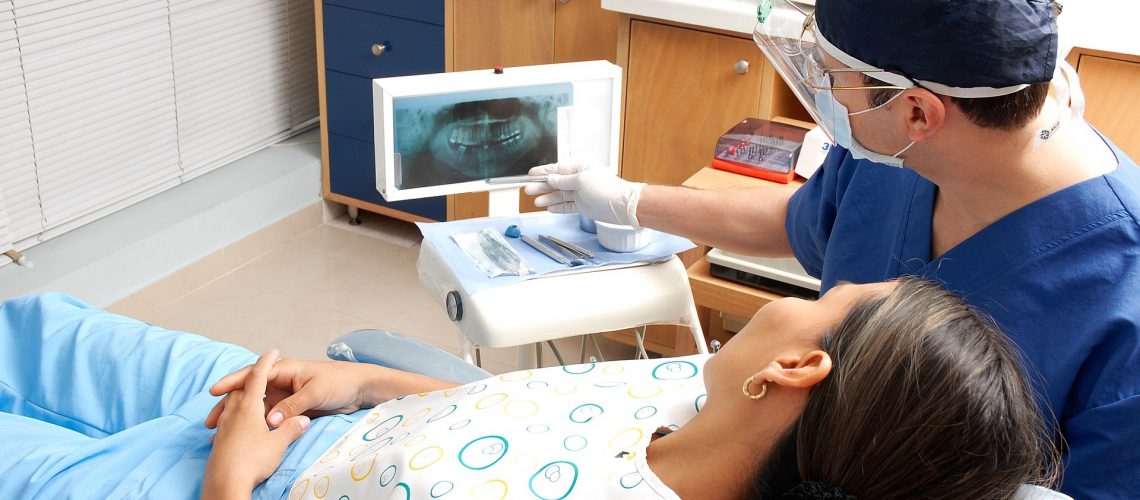 dentist explaining x-ray results to a patient during a visit