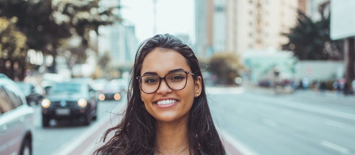 Girl smiling, standing on the road