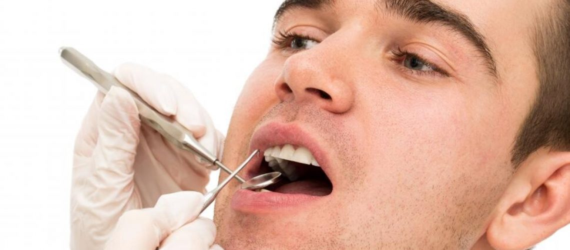A close image of a man’s face during a dental examination