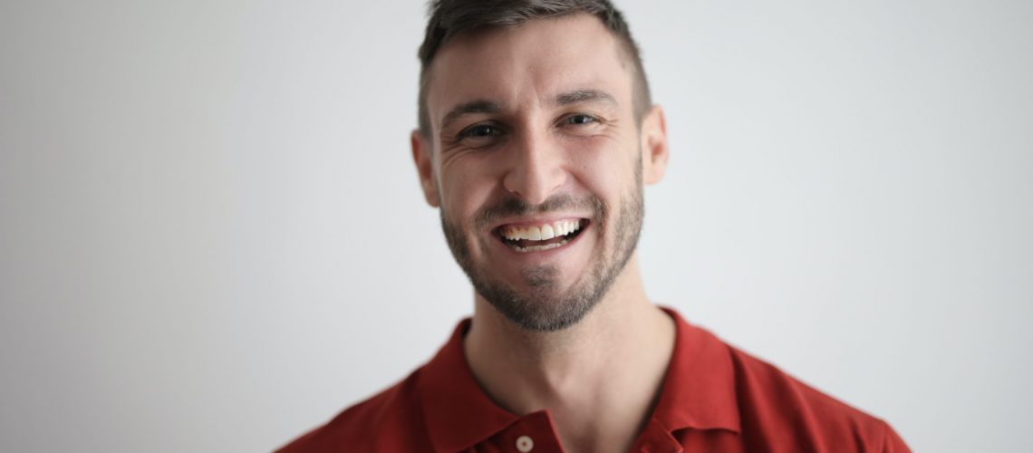 A man smiling after a dental cleaning