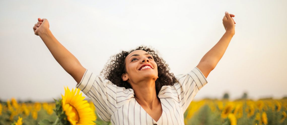 Woman smiling in sunflower field