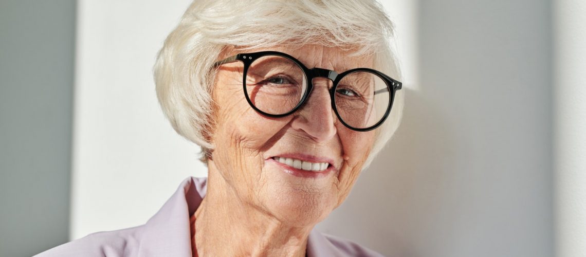 woman with glasses smiling