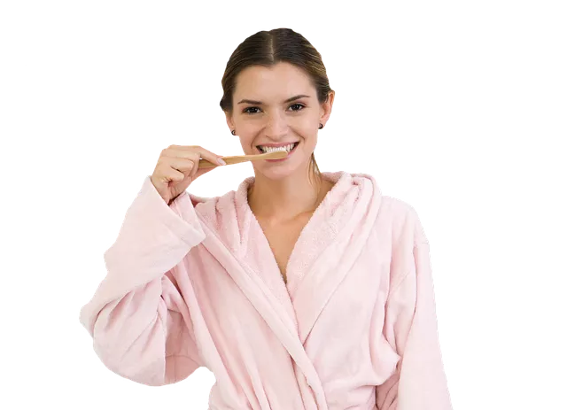 woman in robe brushing teeth